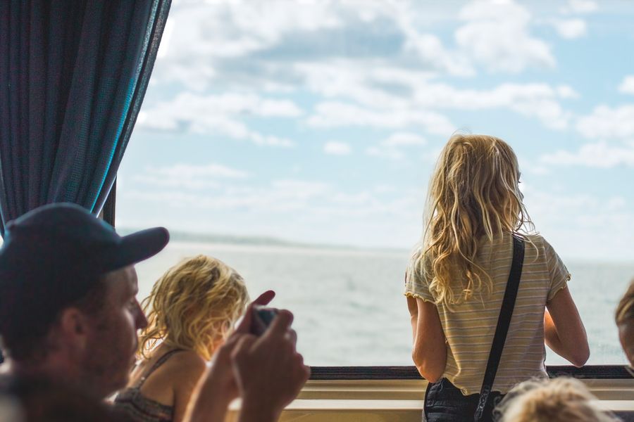 Children looking out at the sea from a ferry window